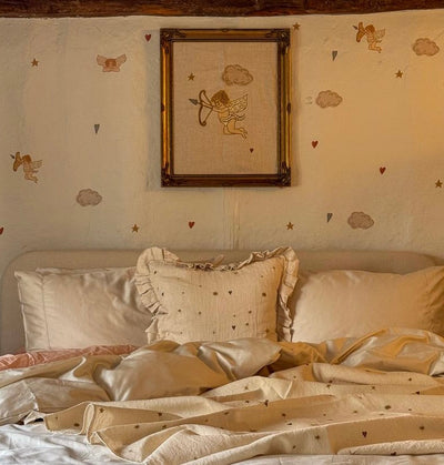 Cherub linen tea towel — lifestyle photo of the design in a bedroom setting