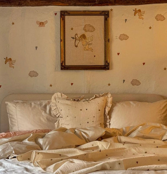 Cherub linen tea towel — lifestyle photo of the design in a bedroom setting