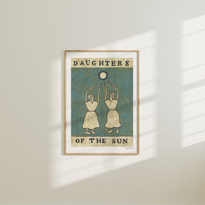Framed artwork titled 'Daughters of the Sun' on a wall.