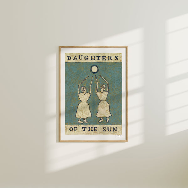 Framed artwork titled 'Daughters of the Sun' on a wall.