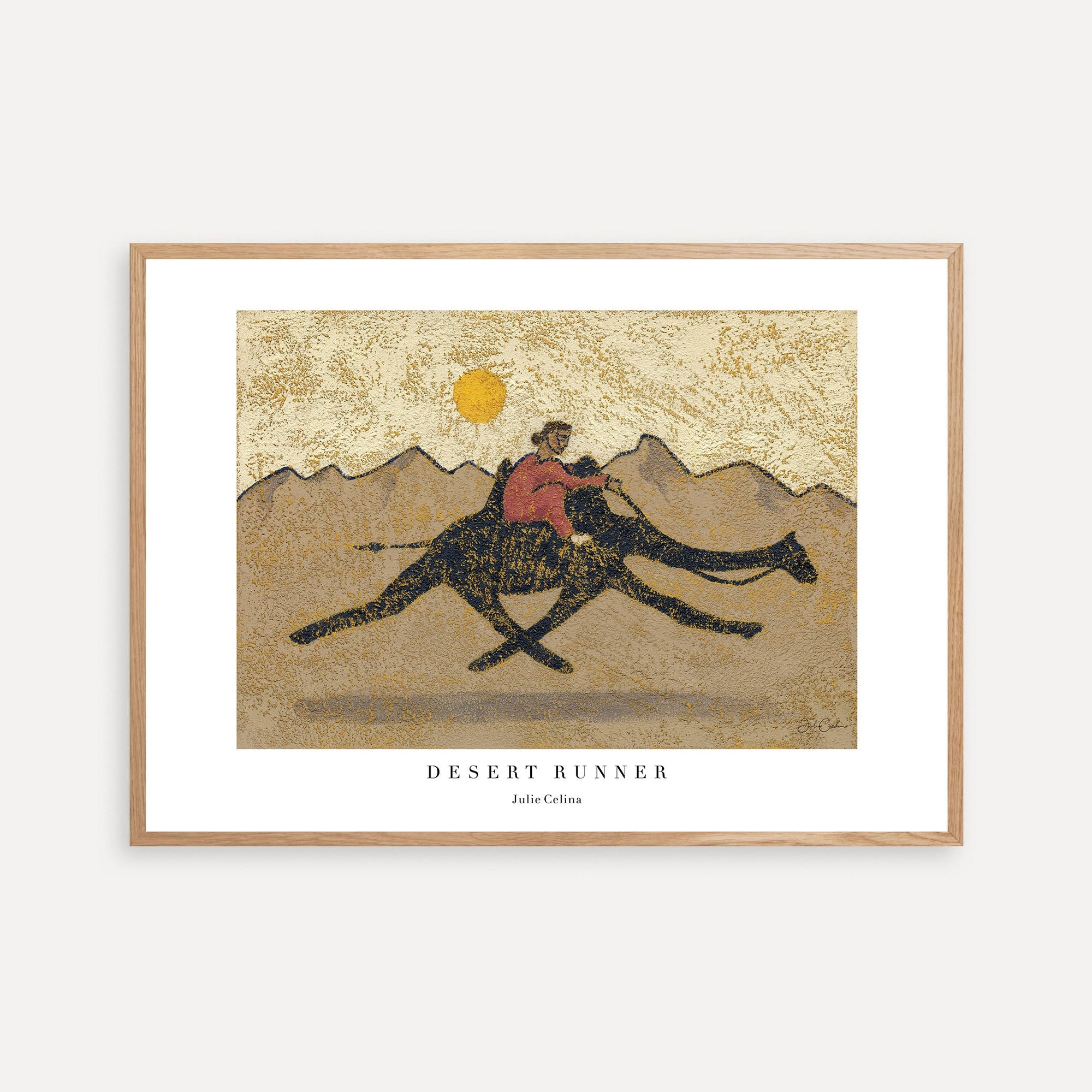 a print of a person riding a camel in the desert
