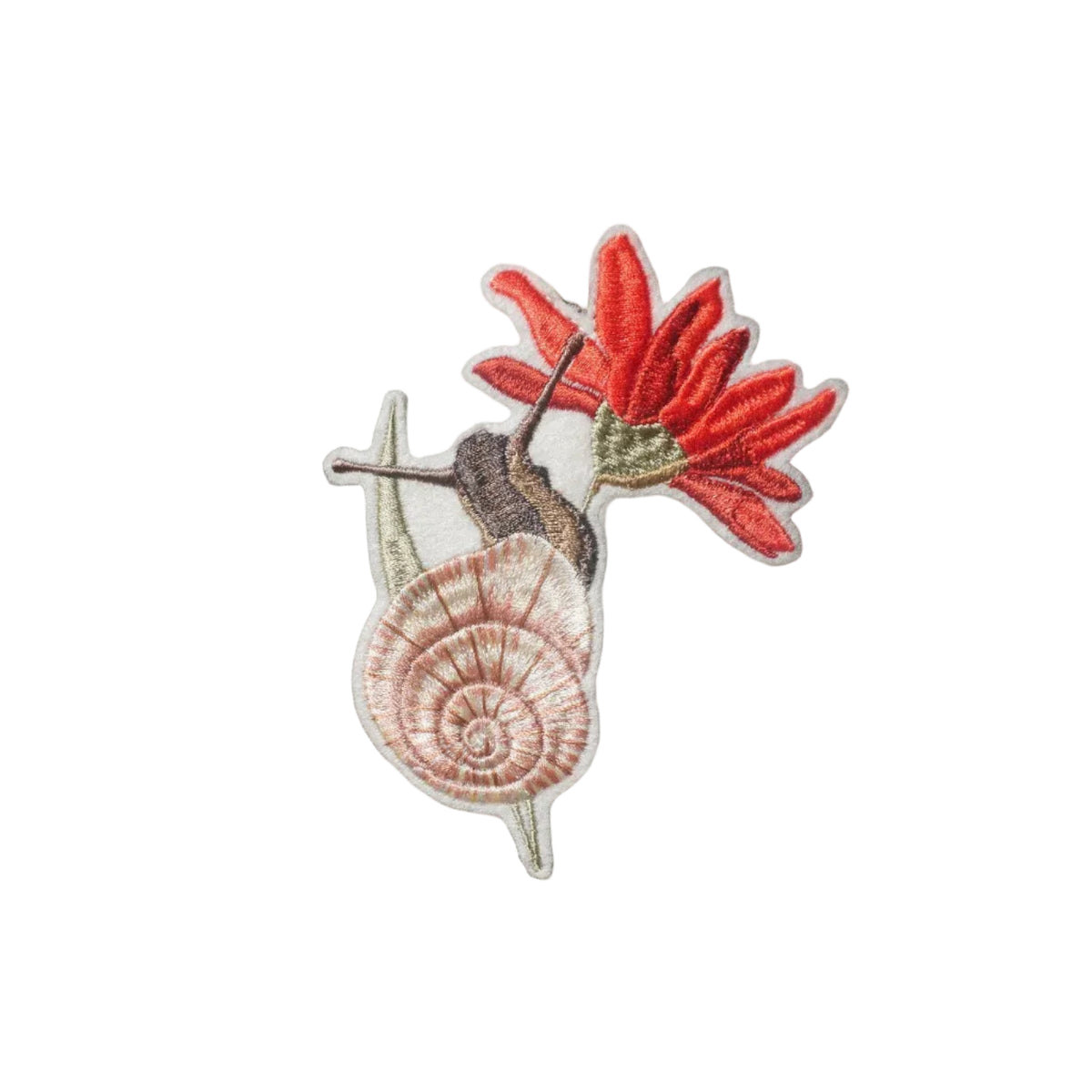 Close-up of an embroidered garden snail decoration with a pink spiral shell and red flower, finished with an olive green velvet ribbon.