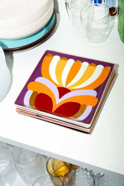 Octaevo Elysia Ceramic Tray with bold, abstract patterns displayed on a white shelf among glassware.