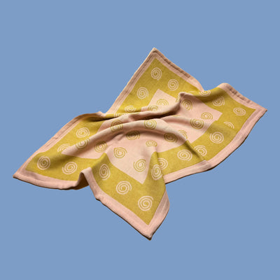 pink and green cotton dish towel / tea towel with graphic spiral swirl emoji pattern, made in portugal, designed in sweden