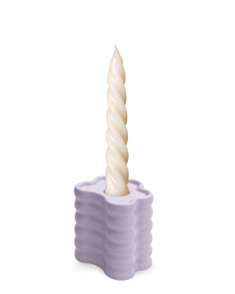 A twisted ivory candle sits in OCTAEVO’s hand-glazed Flora Candle Holder in Purple against a white background.