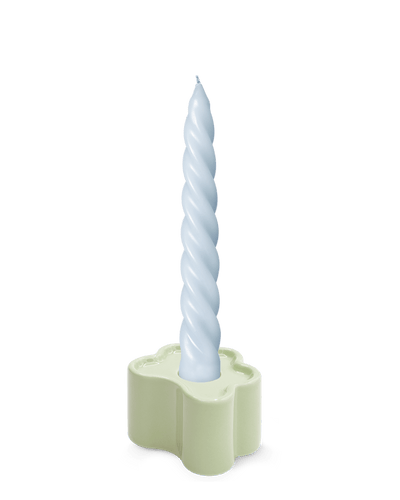 A light blue twisted candle in OCTAEVO's Flora Candle Holder in Mint, a hand-glazed ceramic flower shape, on white background.