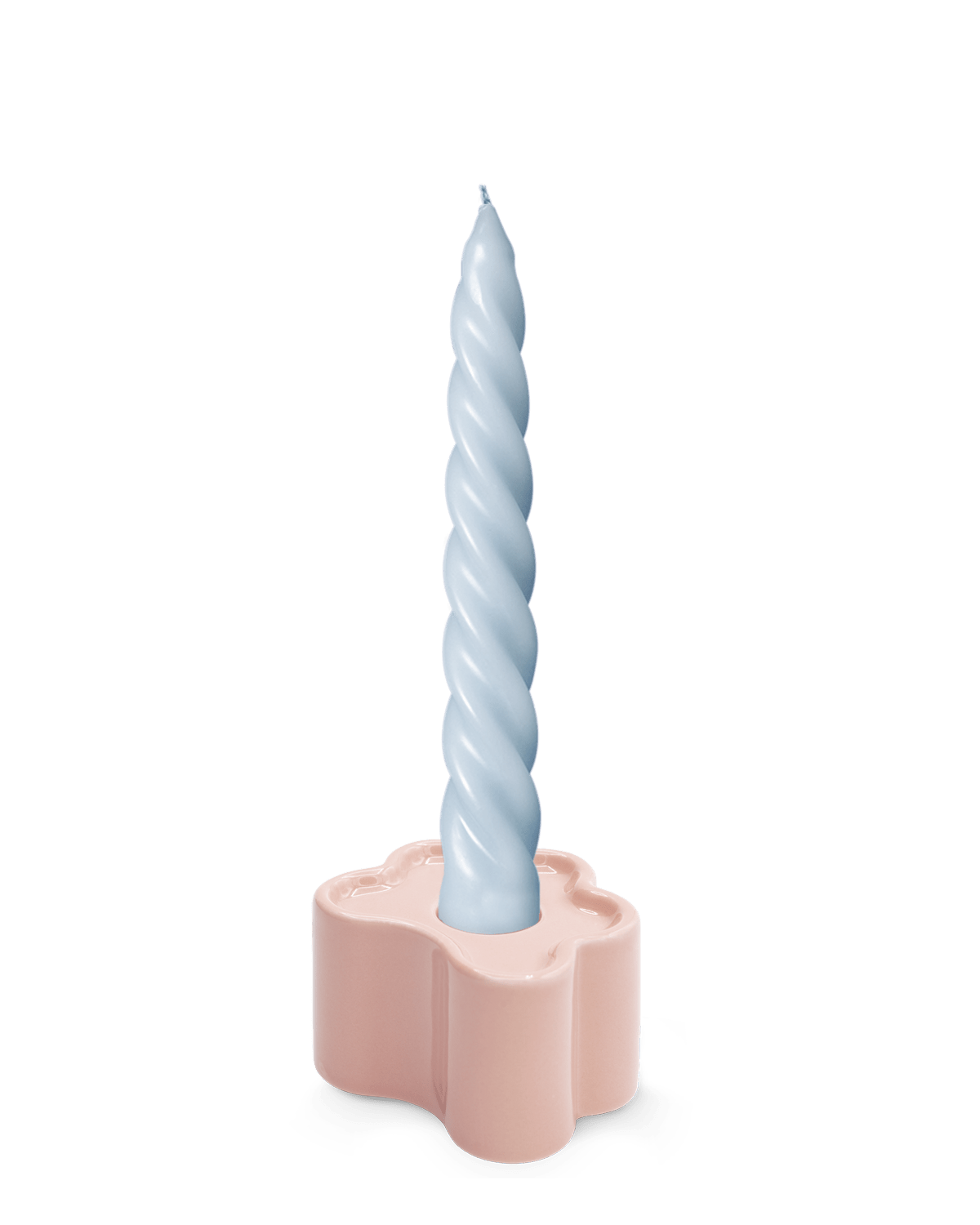 A light blue twisted candle in the hand-glazed OCTAEVO Flora Candle Holder in Pink.