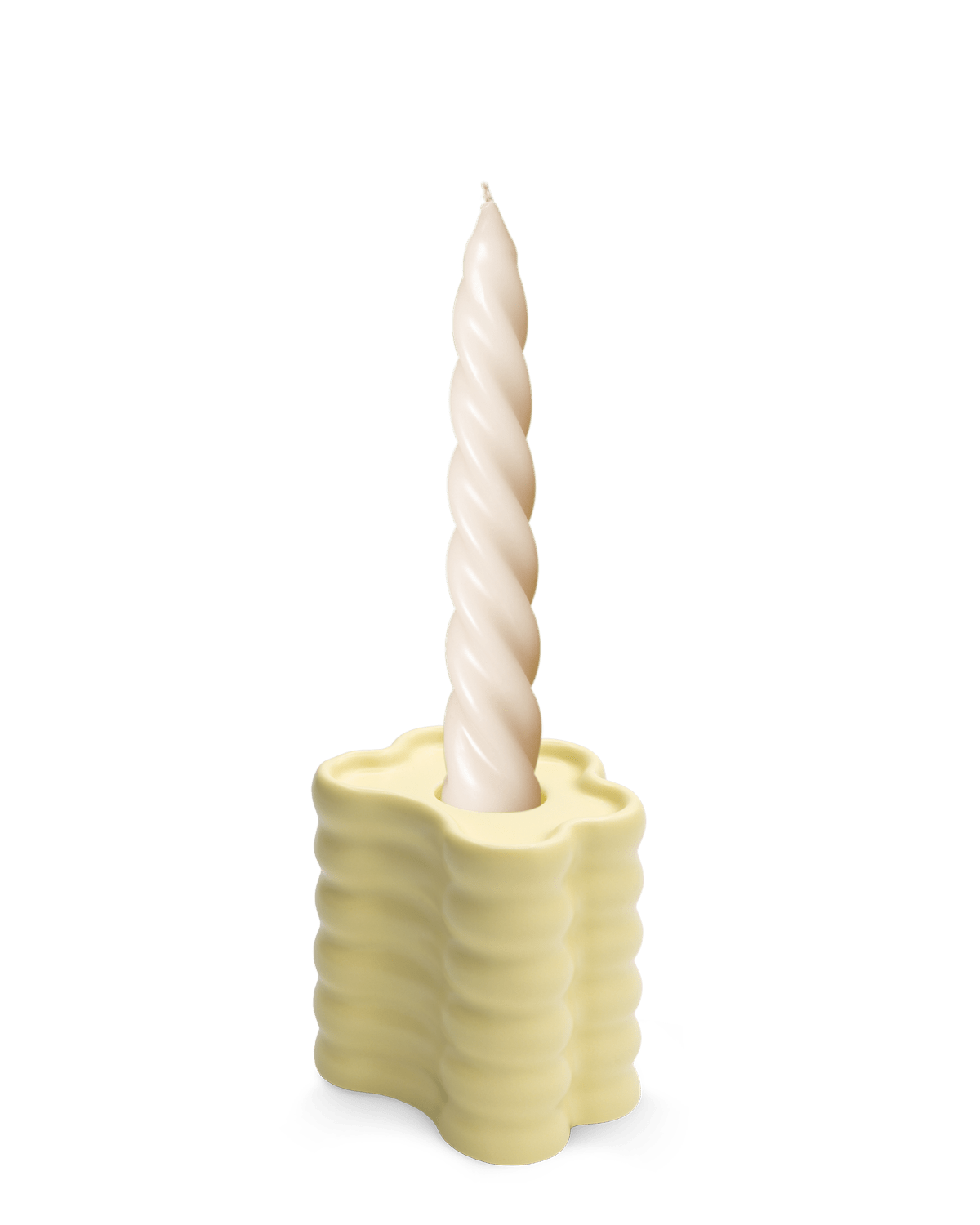 A twisted white candle sits in an OCTAEVO Flora Candle Holder in Yellow, its wavy ceramic design shown on a plain white background.