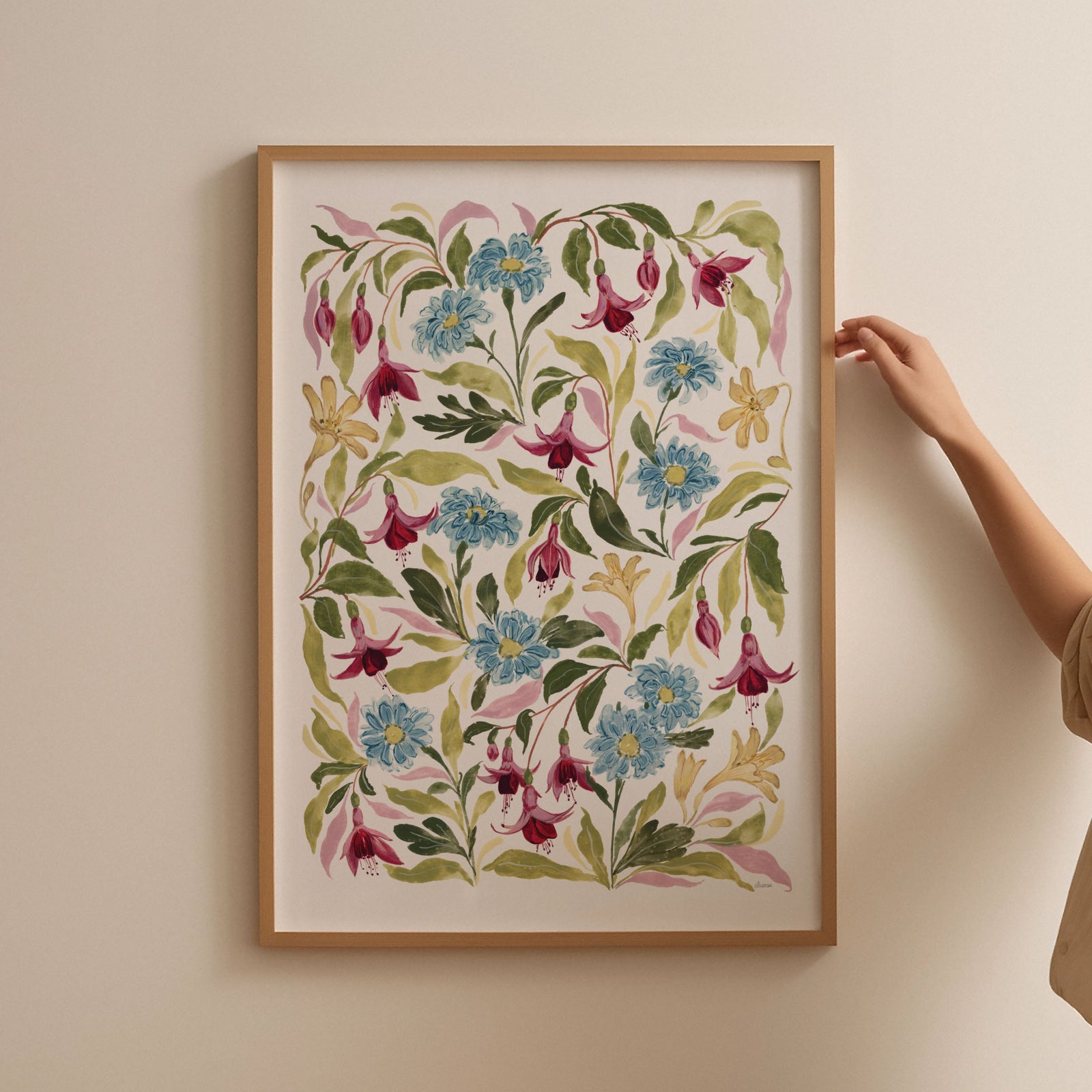 fuchsia print styled in a thin light oak frame in a2 against a blank wall