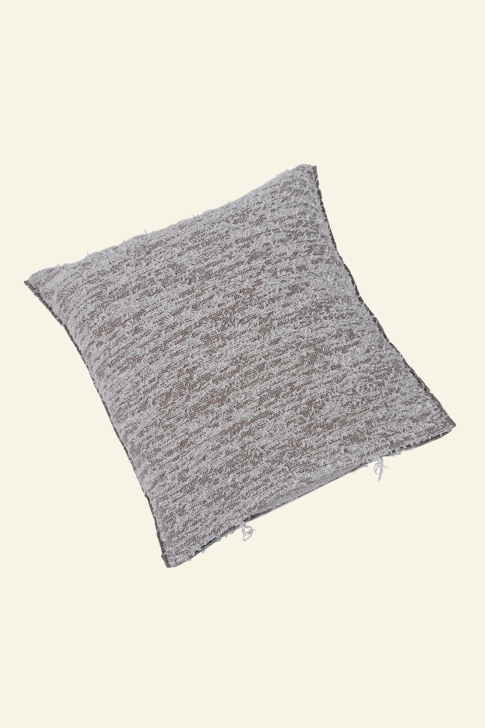 flat laid beige fuzzy knit pillowcase in organic cotton and recycled polyamide