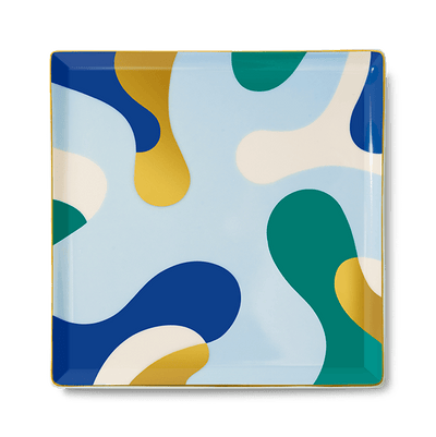 The Gaia Ceramic Tray by Octaevo is a chic square catchall with blue, green & yellow shapes and gold foil accents.