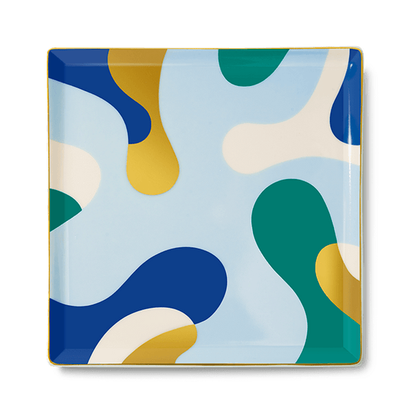 The Gaia Ceramic Tray by Octaevo is a chic square catchall with blue, green & yellow shapes and gold foil accents.