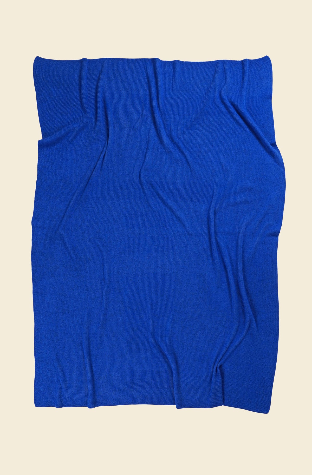 back side of blue geometric column knit blanket in merino wool and organic cotton