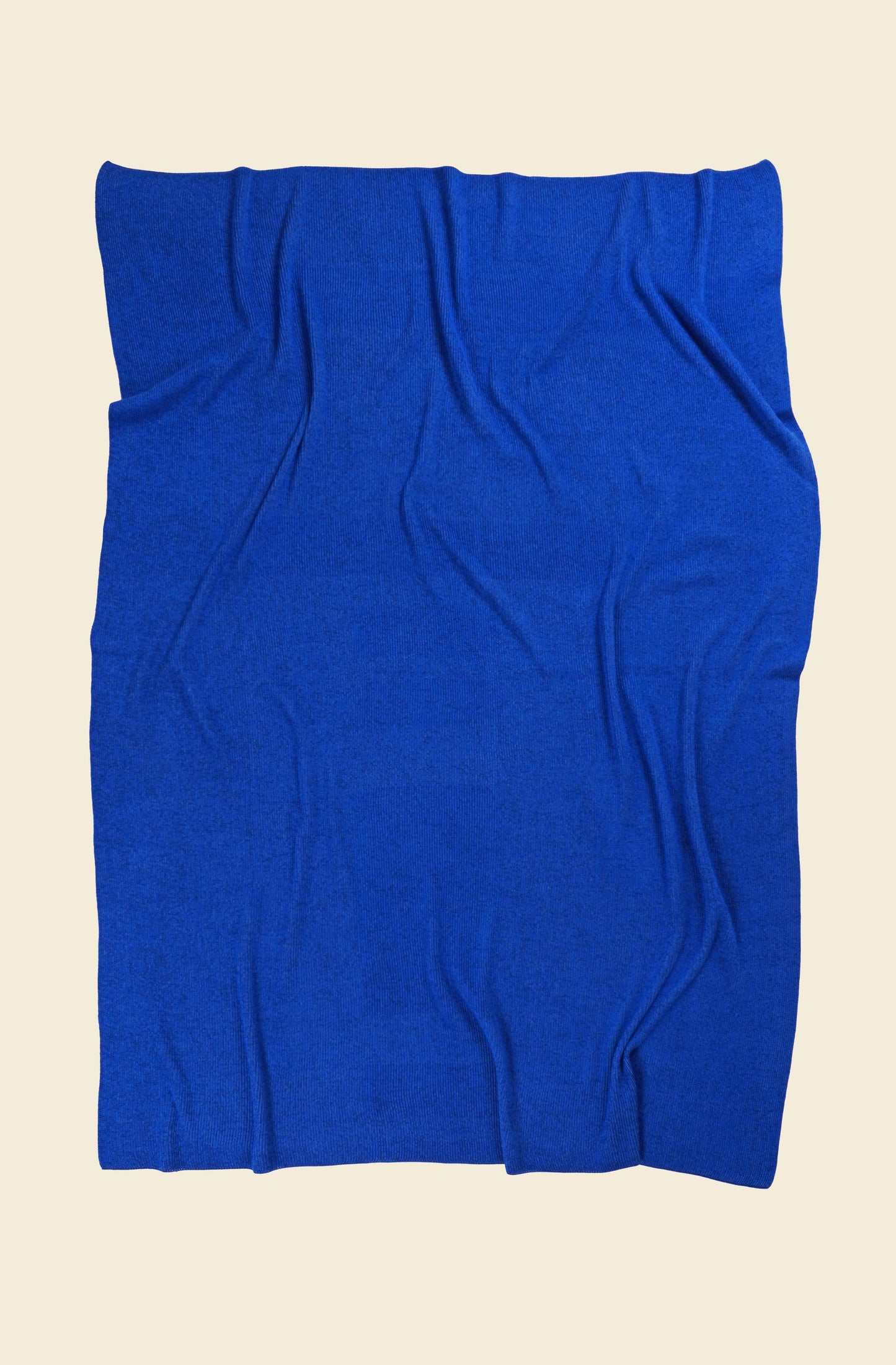back side of blue geometric column knit blanket in merino wool and organic cotton