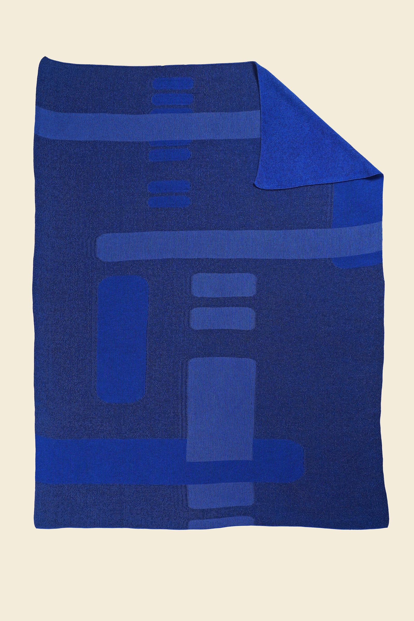 blue geometric column knit blanket with flipped corner in merino wool and organic cotton
