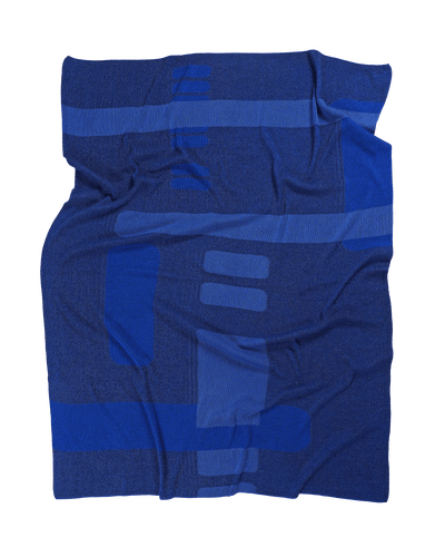 front side of blue geometric column knit blanket in merino wool and organic cotton