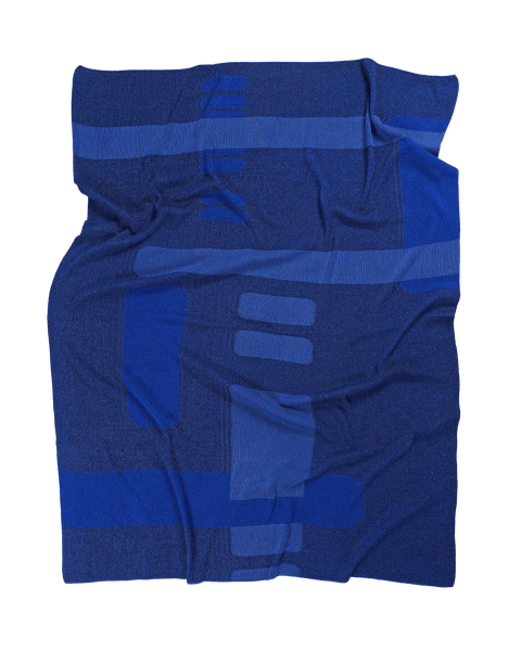 front side of blue geometric column knit blanket in merino wool and organic cotton