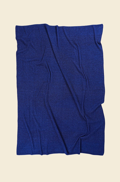back side of blue/purple geometric ikat knit blanket in merino wool and organic cotton