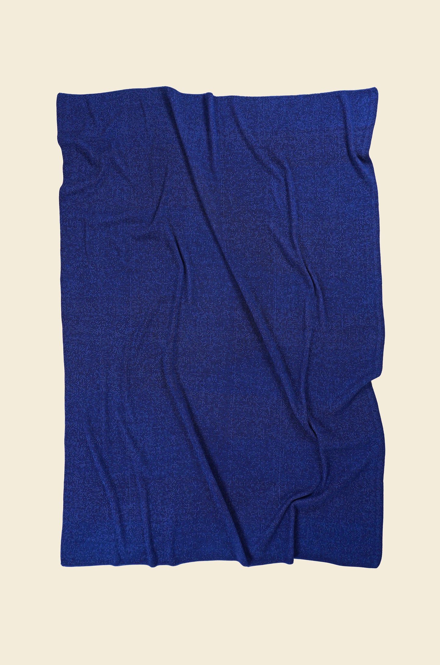 back side of blue/purple geometric ikat knit blanket in merino wool and organic cotton