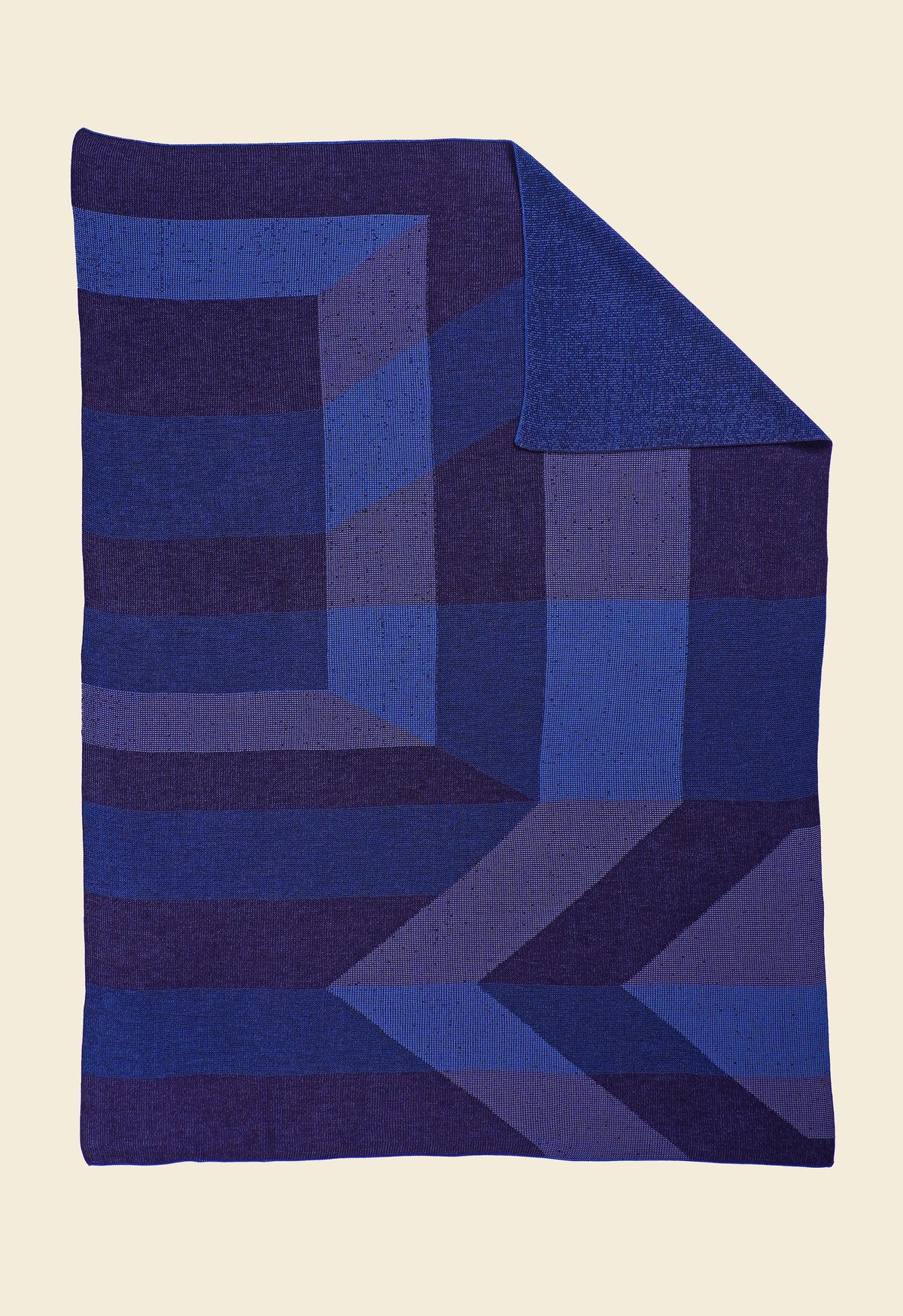 blue/purple geometric ikat knit blanket with flipped corner in merino wool and organic cotton