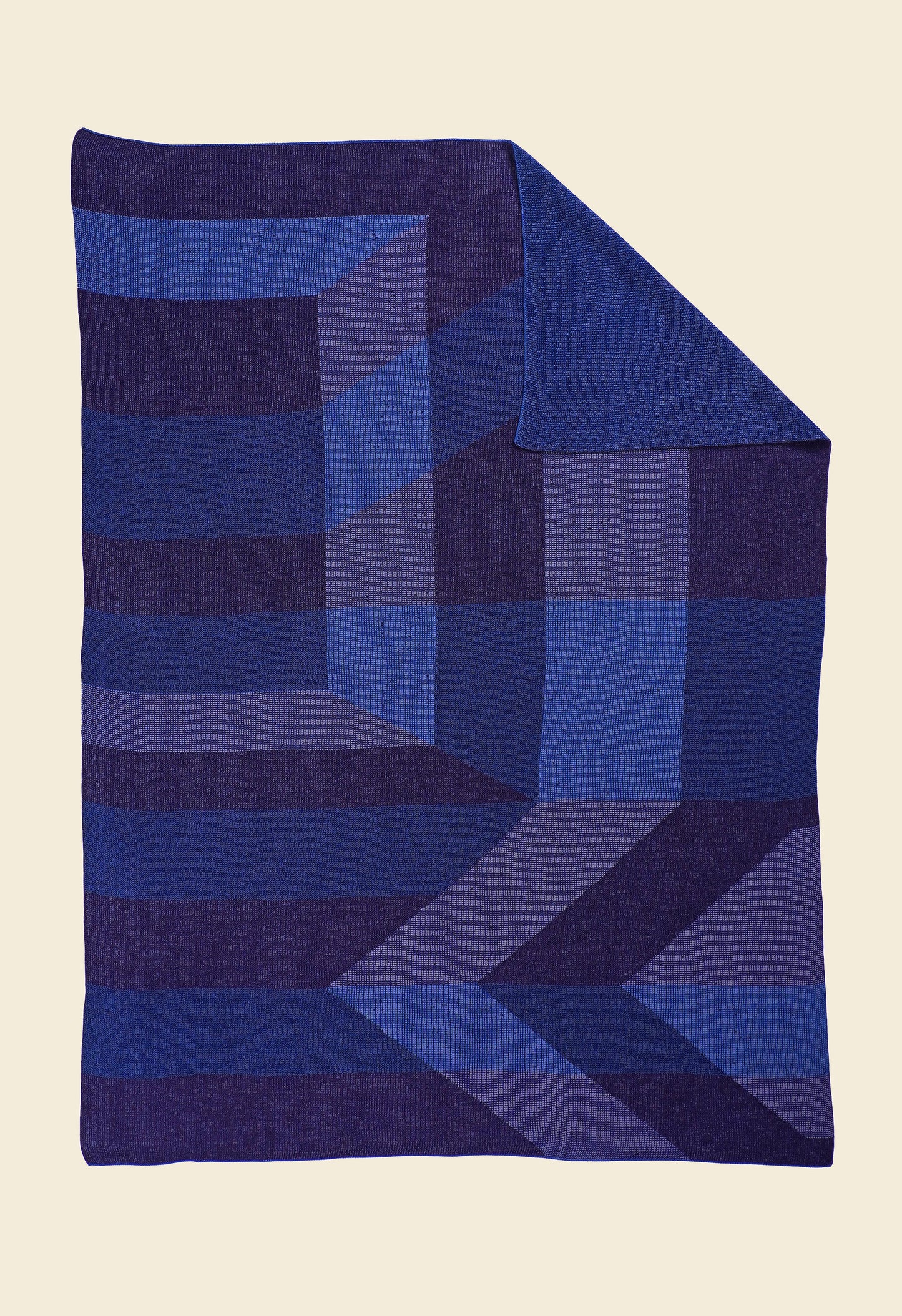 blue/purple geometric ikat knit blanket with flipped corner in merino wool and organic cotton