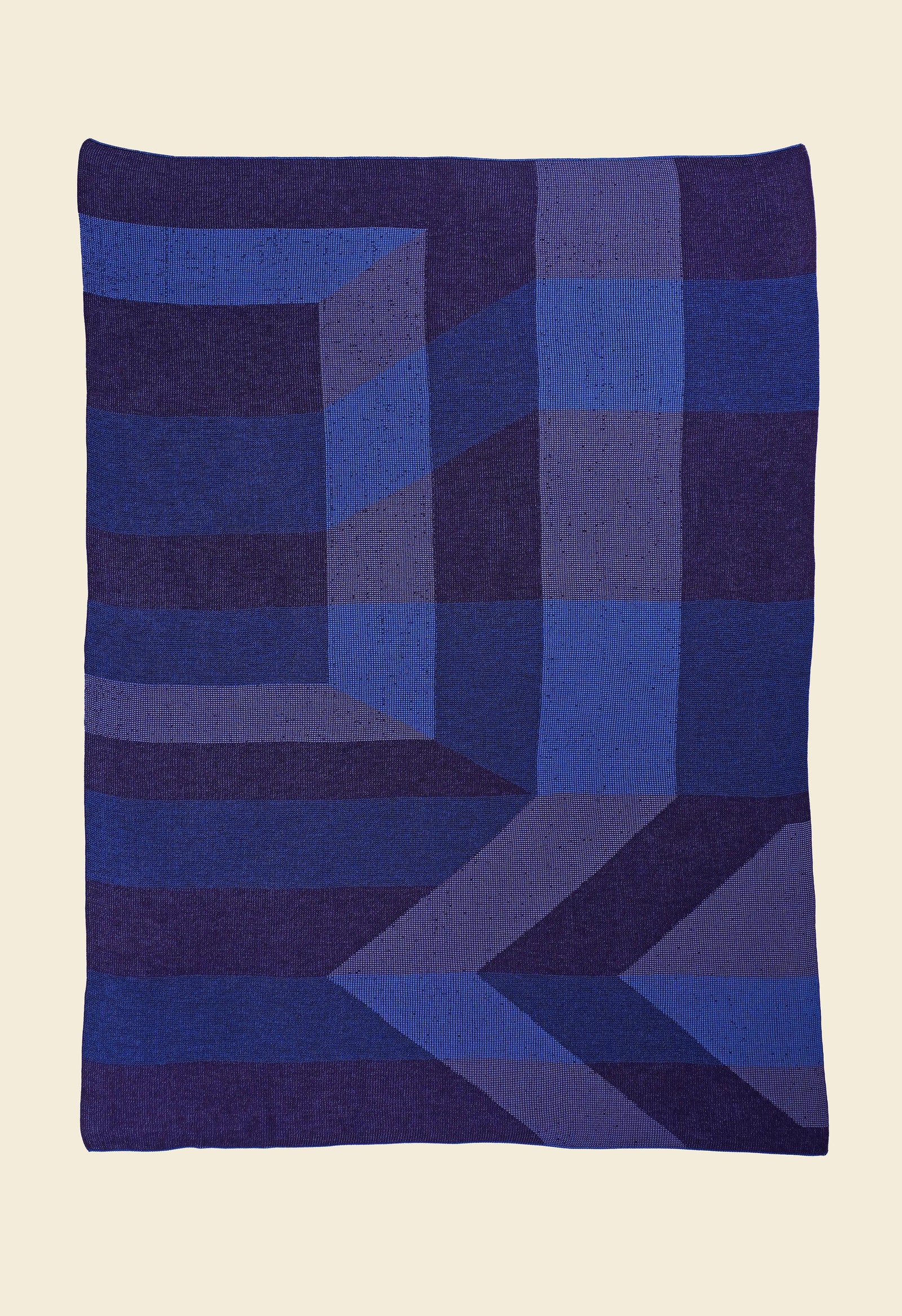 laid flat blue/purple geometric ikat knit blanket in merino wool and organic cotton