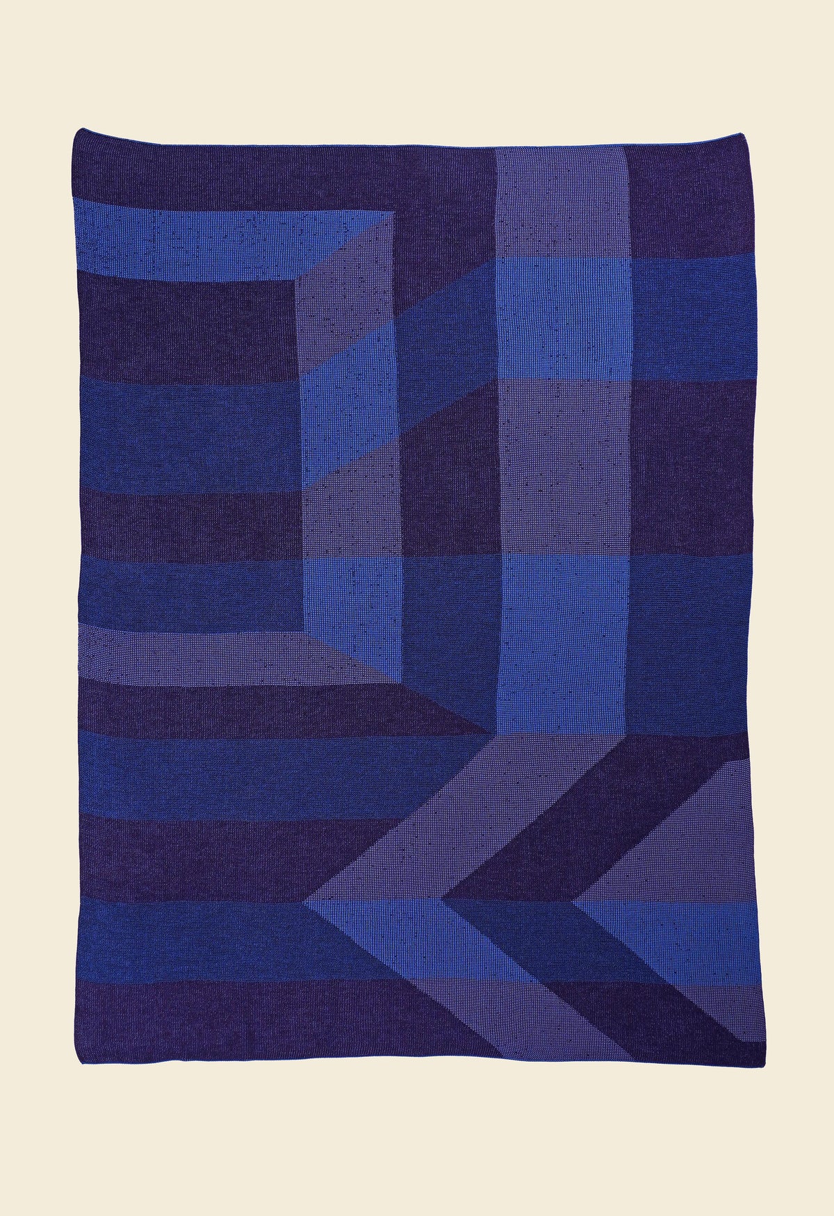 laid flat blue/purple geometric ikat knit blanket in merino wool and organic cotton