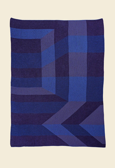 laid flat blue/purple geometric ikat knit blanket in merino wool and organic cotton