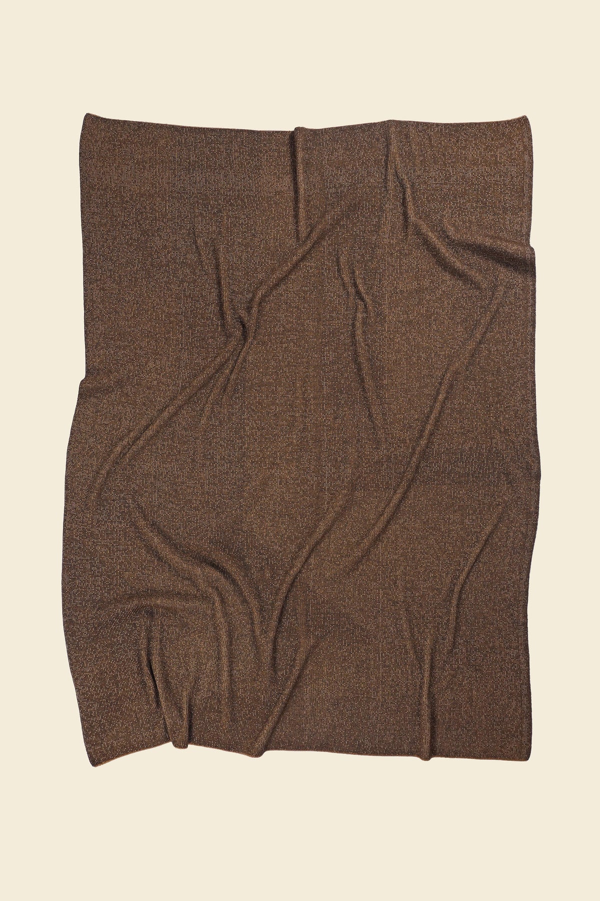 back side of brown/gold geometric ikat knit blanket in merino wool and organic cotton