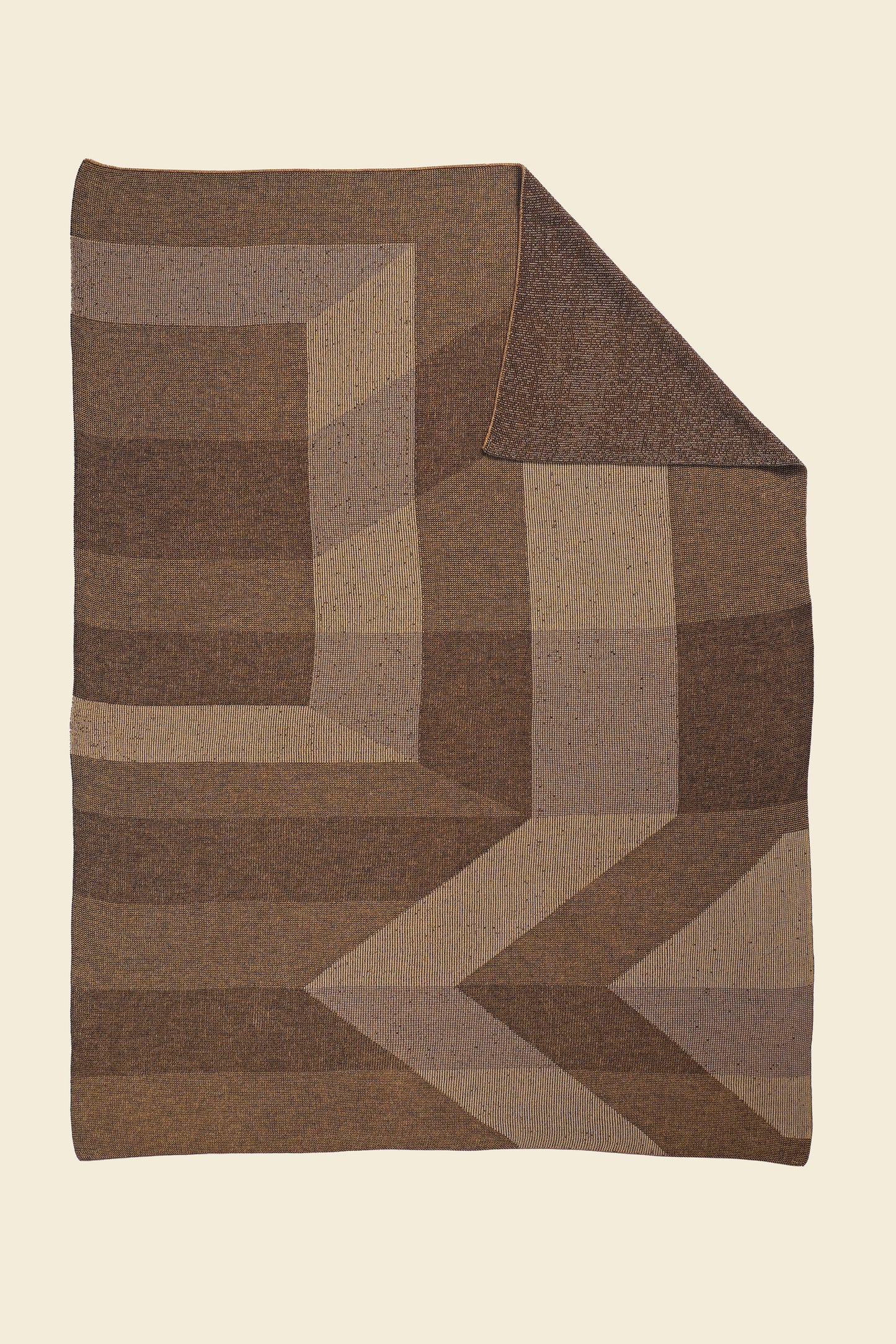 brown/gold geometric ikat knit blanket with flipped corner in merino wool and organic cotton