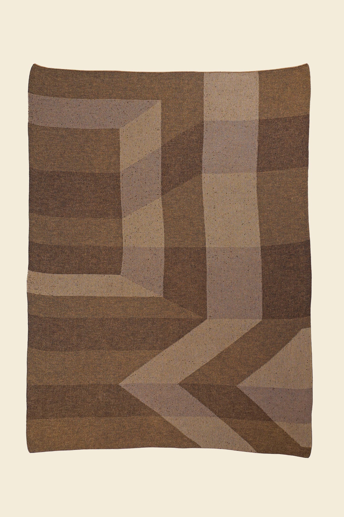 laid flat brown/gold geometric ikat knit blanket in merino wool and organic cotton