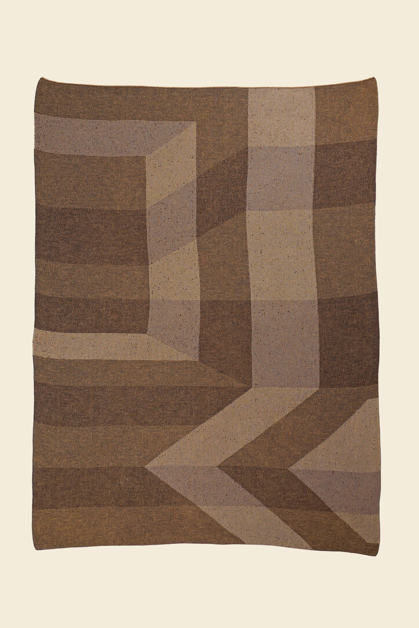 laid flat brown/gold geometric ikat knit blanket in merino wool and organic cotton