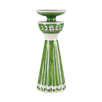 Green ceramic candle holder with floral design on a white background