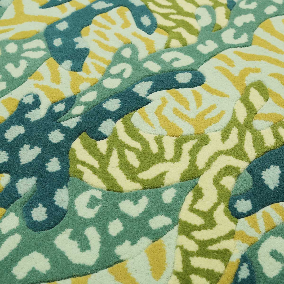 Detail of hand tufted Green Big Cat Camo rug which mixes camouflage and animal print to make a striking statement rug.