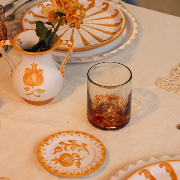 orange halfway glass set on a table - lifestyle
