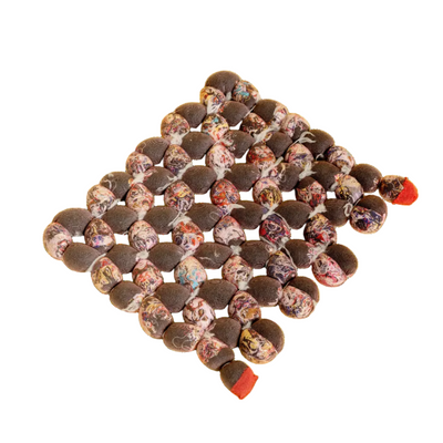 front view of hand-knotted knit seat cushion with transparent cover filled with upcycled materials