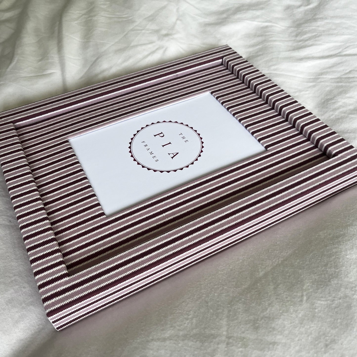 Handmade blush and burgundy zigzag picture frame angled full view on plain background