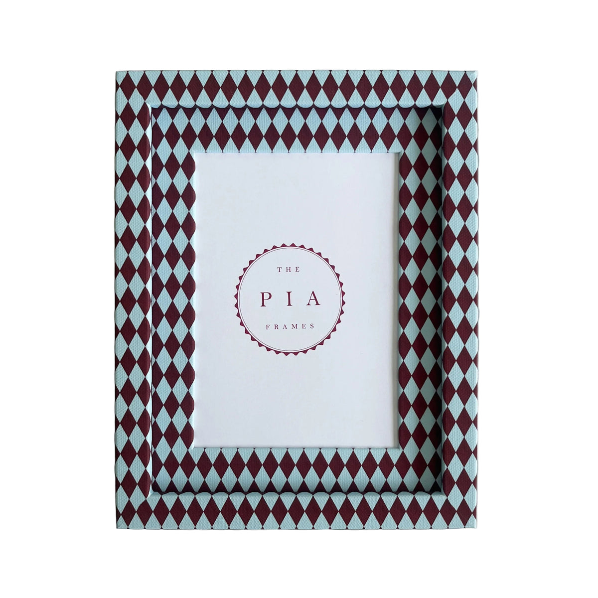 Handmade burgundy and blue harlequin fabric frame, on a white linen fabric