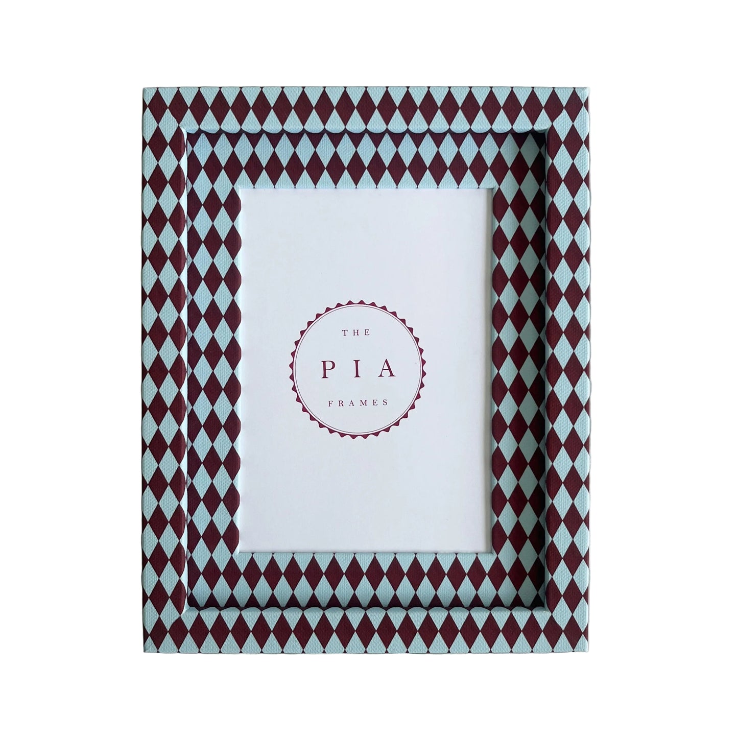 Handmade burgundy and blue harlequin fabric frame, on a white linen fabric