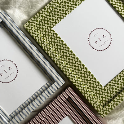 Set of three handmade colourful fabric picture frames on a white fabric background