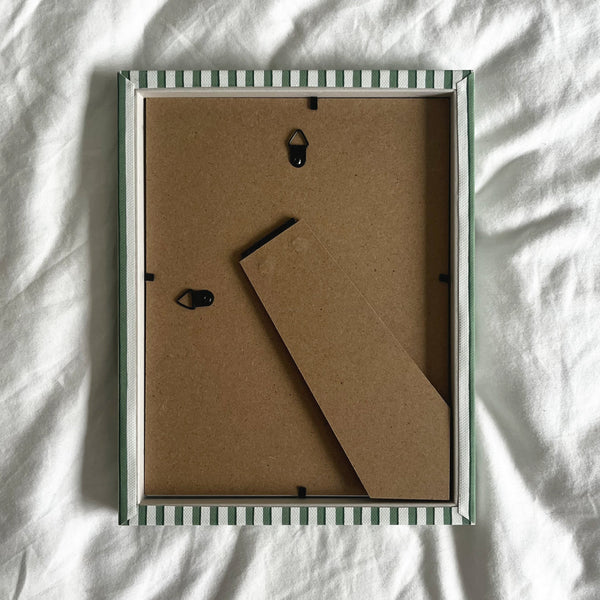 Back view of handmade green vanguard stripe picture frame, showing wall fittings and frame structure