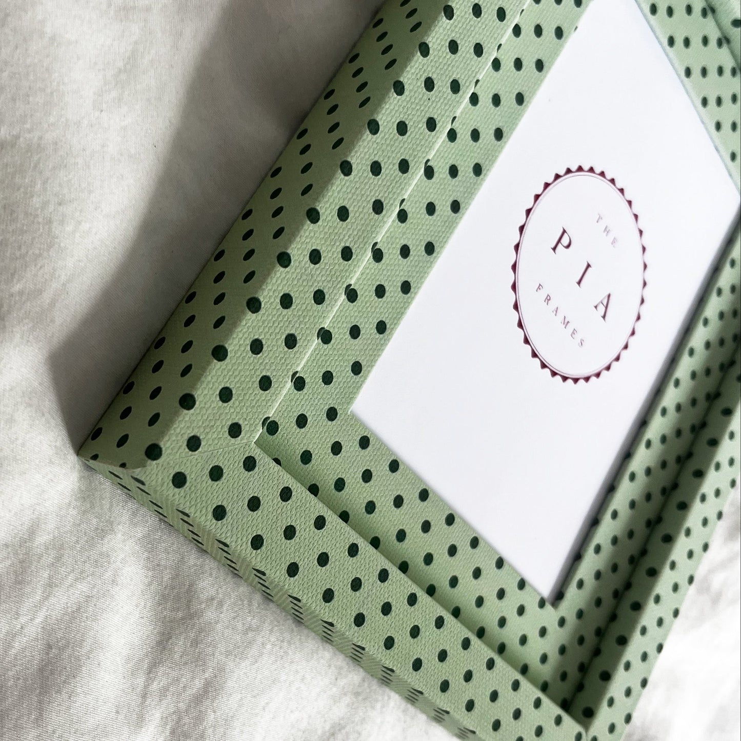 Side view of handmade mint and jade Pembroke polka dot fabric picture frame, showcasing its design and depth