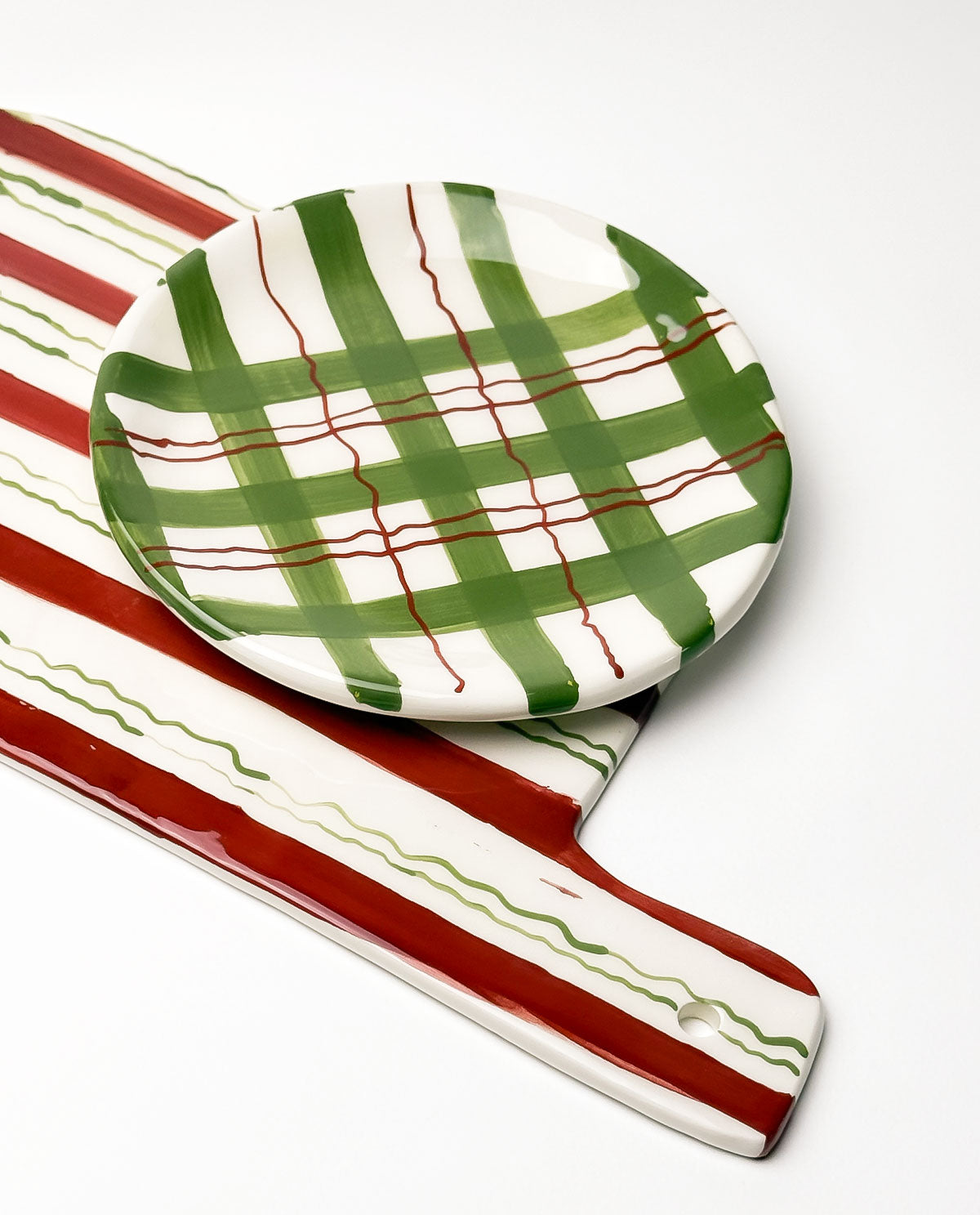 Ceramic platter with green and red pattern on a white background
