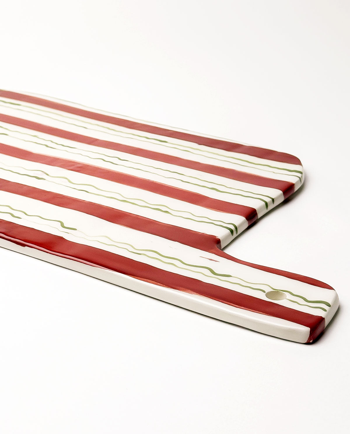 Festive ceramic serving board with red and green stripes