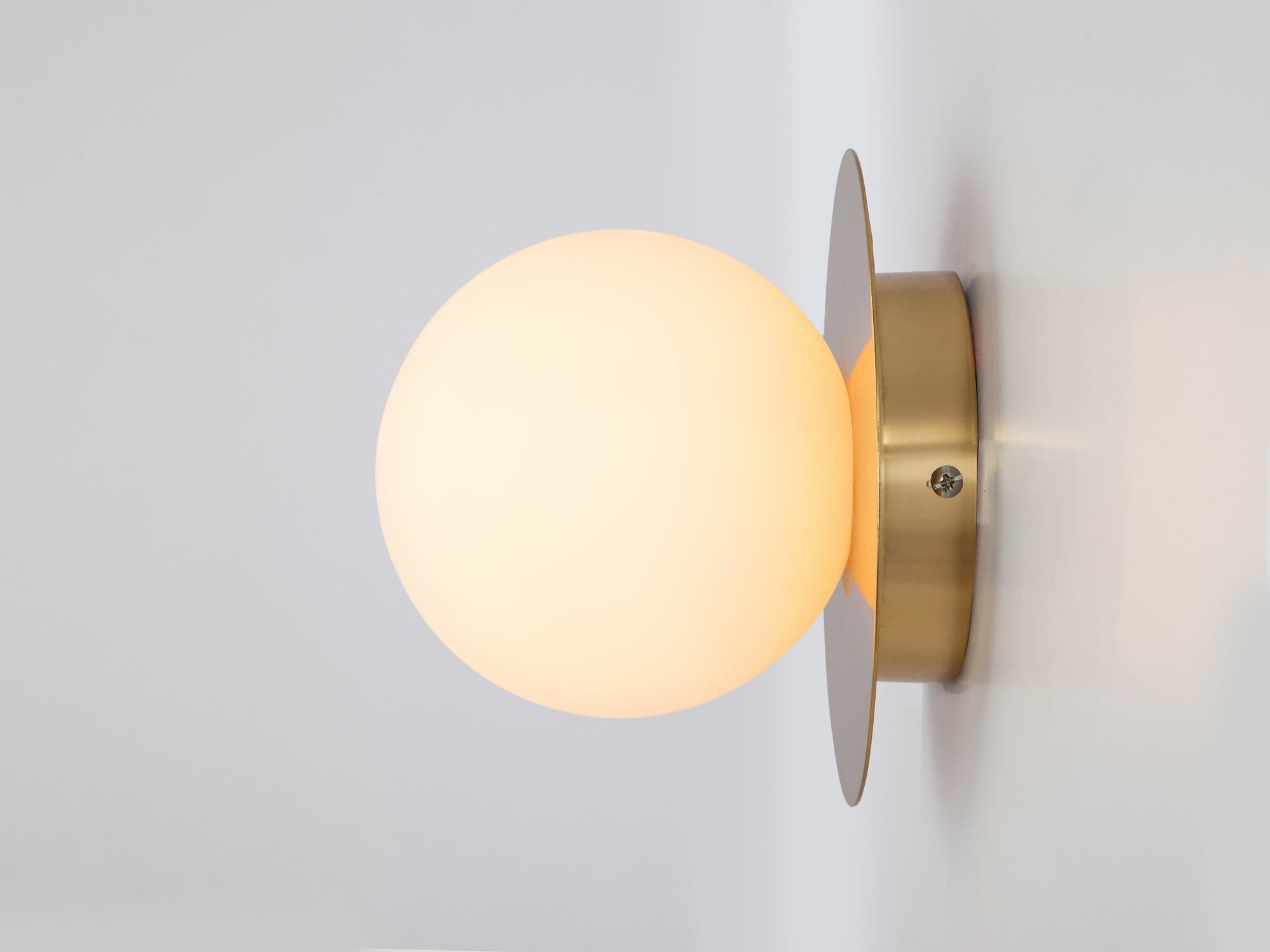 Brass opal disc wall light