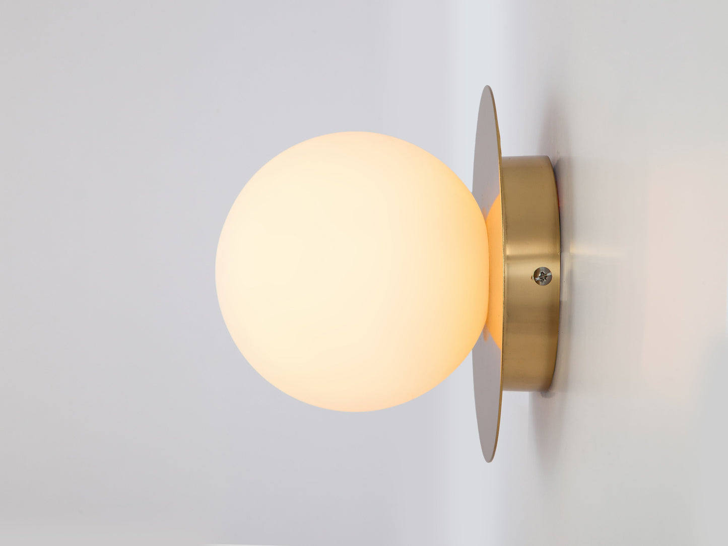 Brass opal disc wall light
