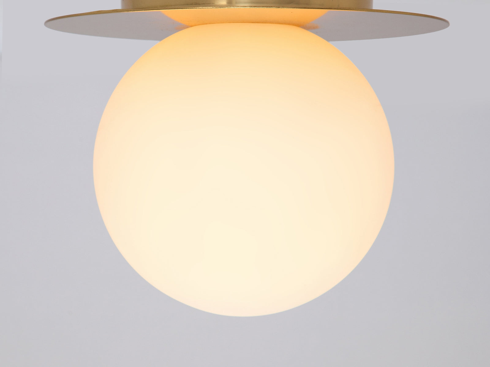 Brass opal disc wall light