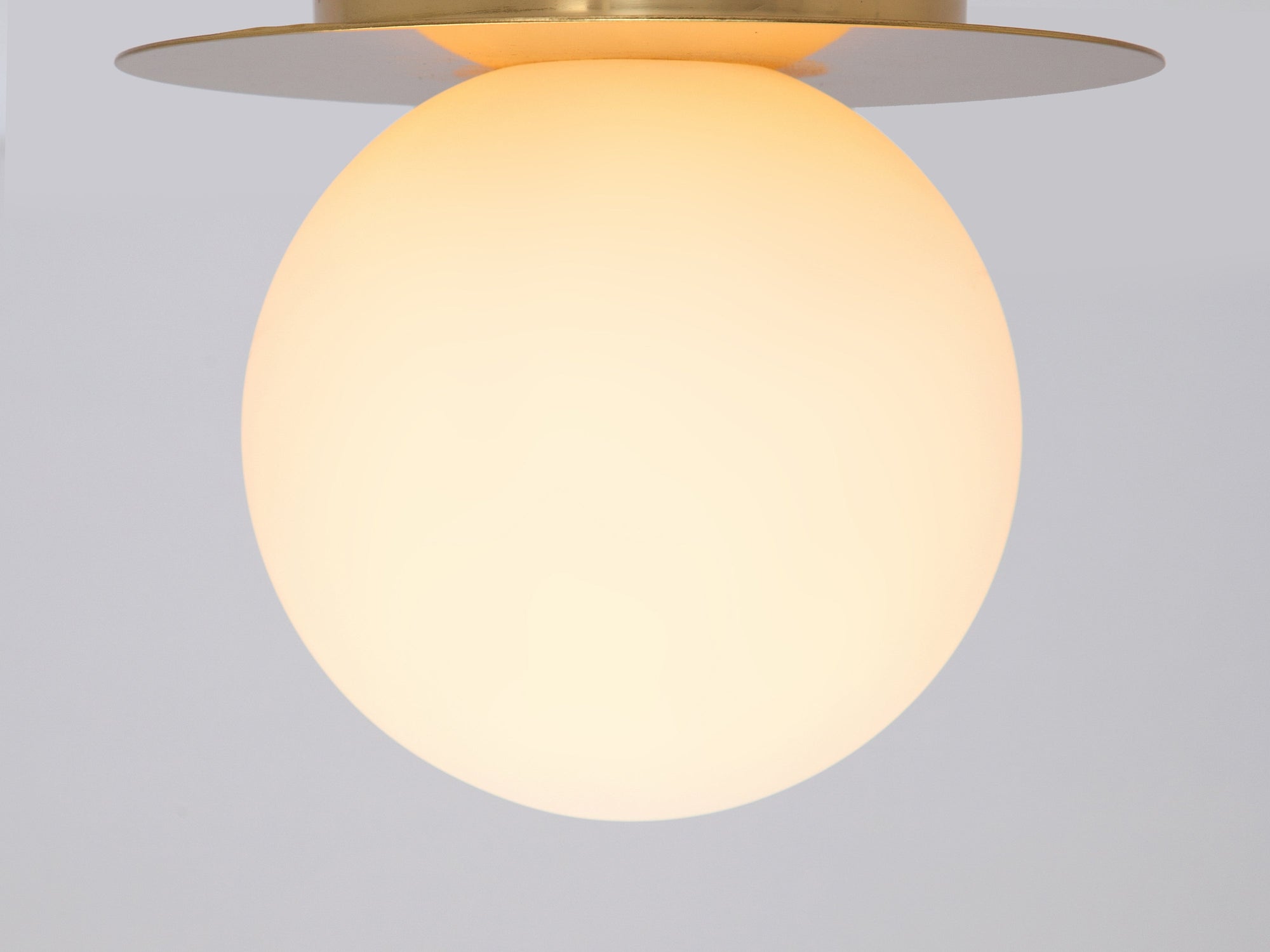 Brass opal disc wall light