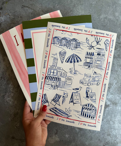 I Love The Seaside print, toile-style beach scene with ice cream van and seagulls being held
