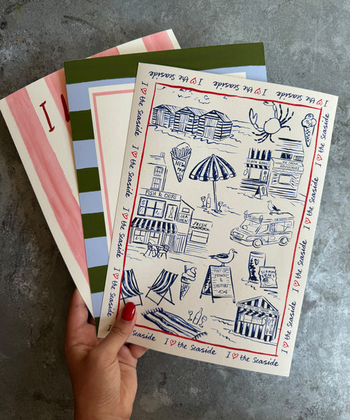 I Love The Seaside print, toile-style beach scene with ice cream van and seagulls being held
